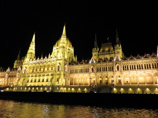 Fototapeta premium The Hungarian Parliament at night with dark sky and reflection in Danube river. It was designed in Neo-Gothic style, although it also bears Renaissance and Baroque stylistic flourishes.