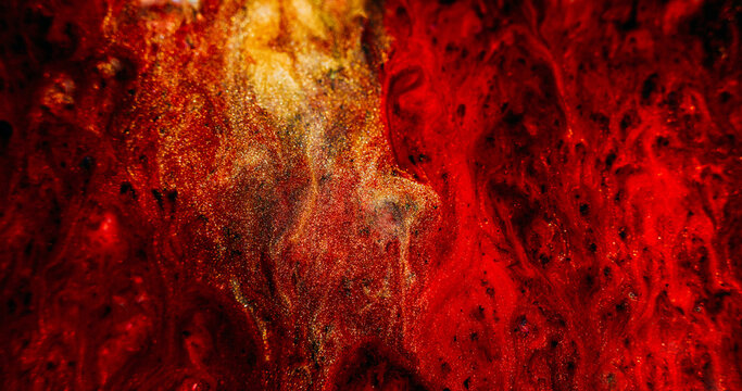 Shimmering mix. Ink stream defocused. Yellow red black sparkling color particles blending on abstract magma leak texture background.