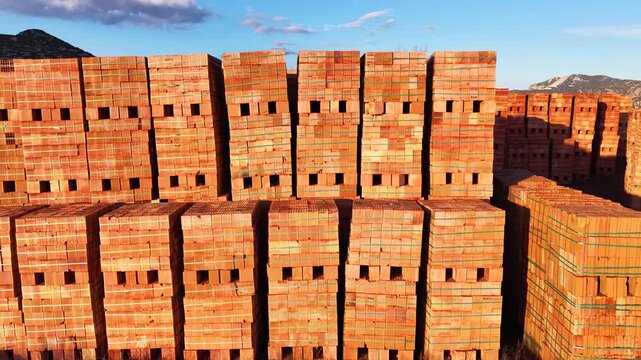 Aerial view of red brick pallets. Construction materials, industrial stock, and building sector