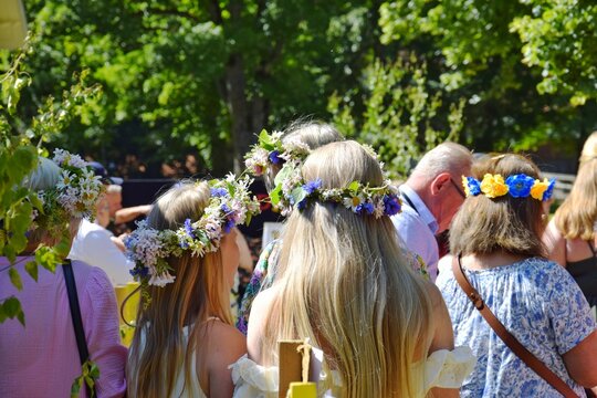 Girls wear wreaths of wildflowers on their heads. Celebrating the traditional midsummer festival.