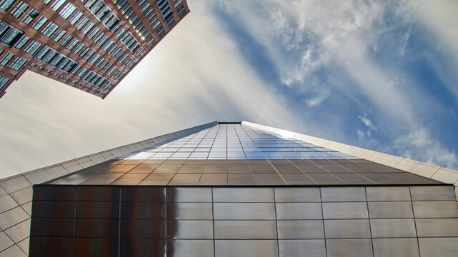 a facade, mirror-smooth and utopian, rises high into the sky