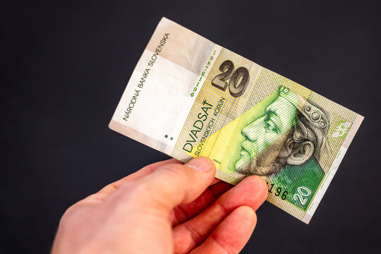 20 Slovak koruna banknote (20 SKK) held in hand before euro adoption. Former currency of the Slovak Republic. Finance, economy and historical money concept.