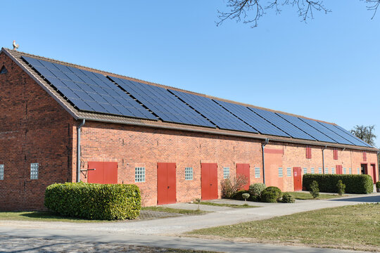 Traditional German barn with repeating solar panels in Lower Saxony countryside