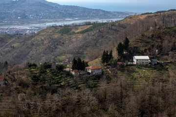 Fototapeta premium Rural hillside village with terraced fields and river valley view around Batumi, Gerogia