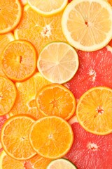 Fototapeta premium Juicy citrus fruit slices as background, top view