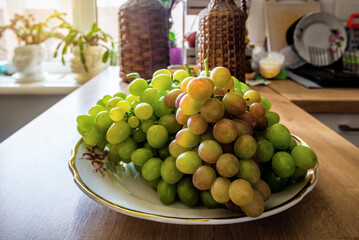 Ripe sweet bunch of grape on the kitchen table