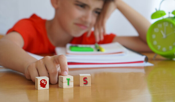 child with TS frustrated doing homework, importance of educational needs and special attention to this disorder.