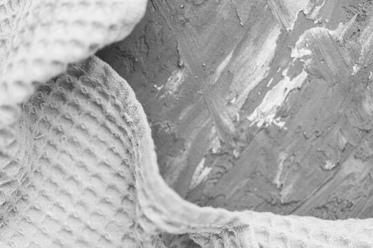 Waffle gray towel on gray textured background. Space for text.