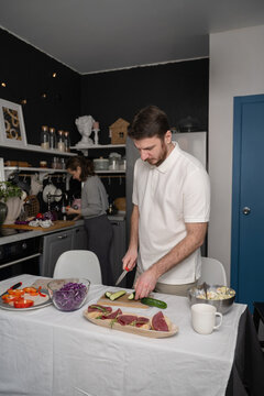 Couple preparing a meal together in a cozy kitchen