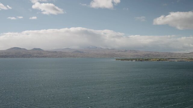 Slow motion handheld footage of lake Sevan in Armenia windy autumn season