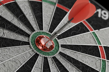 Red dart hitting the center of the bullseye on a dartboard. Closeup concept for business success, goal achievement, accuracy and strategic marketing targets