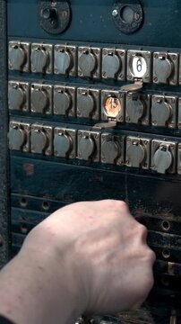 Closeup Of Technician Reconnecting Ancient Jacks On Historic Communication Equipment Panel. Media