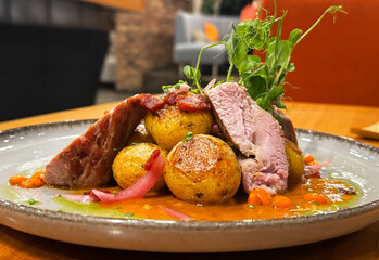 A spicy dish with sliced ​​steak, vegetables in bean sauce and herbs