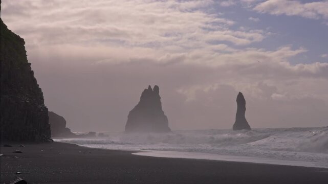 Basalt columns and crashing waves at Reynisfjara Beach in Iceland