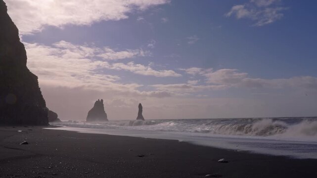 Basalt columns stand tall as waves crash on Reynisfjara Beach