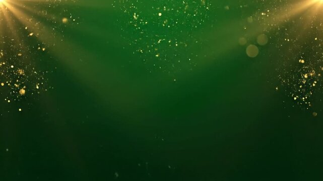 Elegant golden particulate matter drifts downward through deep emerald green atmospheric light rays video footage