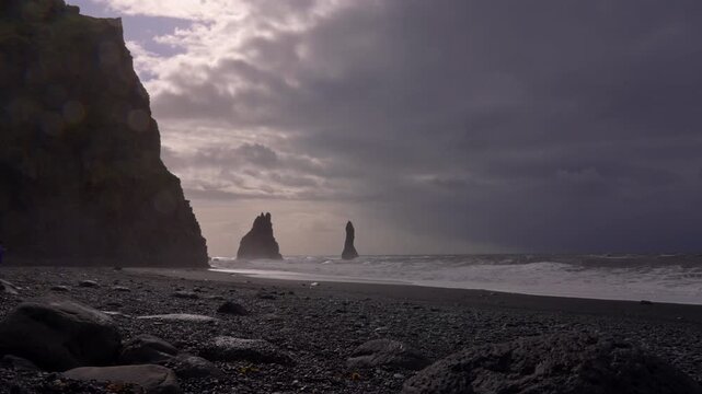 Basalt columns and waves at Reynisfjara Beach during changing weather