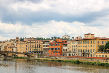 Fototapeta premium Famous historic Ponte Vecchio bridge and old buildings along the Arno river in Florence Italy