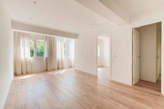 Bright empty living room with large windows
