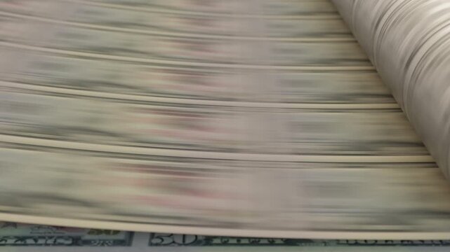 US fifty dollar bills moving through printing press in loop animation. Powerful visual for inflation, monetary policy and financial crisis themes. Part of collection.