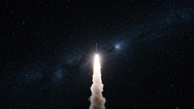 Powerful rocket launch sequence from a pad under a starry night sky