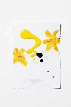 Yellow and maroon nail polish splatter on floral print