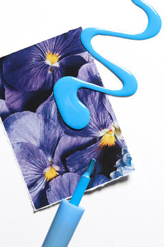 blue nail polish sample on background of photo with flowers