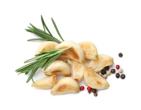 Grilled garlic cloves with spices isolated on white, top view