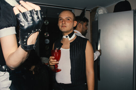 Costume Party Featuring Vibrant Outfits and Themed Drinks at Night