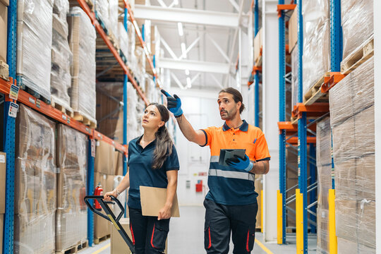 Logistic workers checking inventory and stock in warehouse