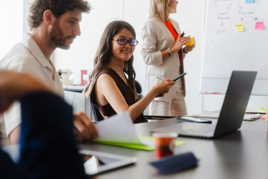 People are sitting in a meeting during a presentation