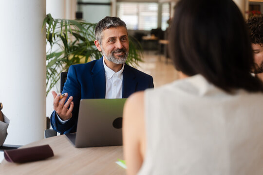 Portrait of a businessman speaks with his colleagues