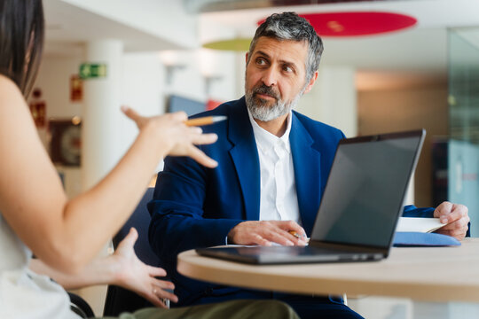 Man and a woman collaborating at a desk