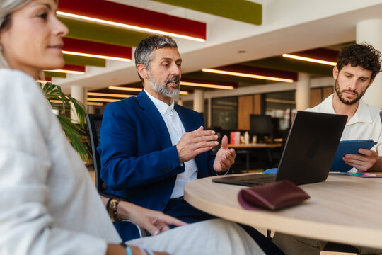 Group of colleagues sitting at a desk