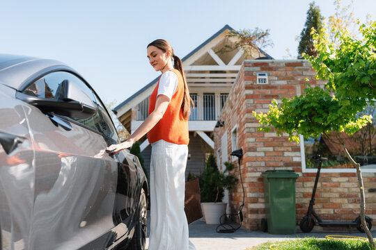 The woman gets into the car