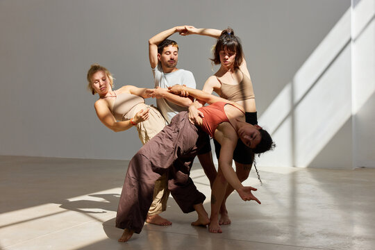Group of dancers performing contemporary choreography indoors