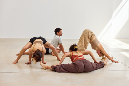 Dynamic group of dancers practicing in a minimalist studio space