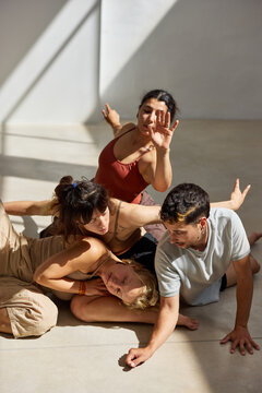 Group of dancers engaged in expressive movement in a studio