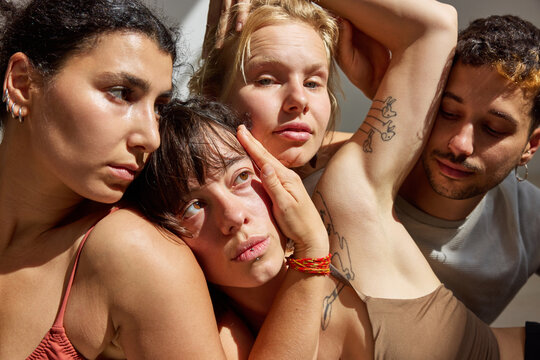 Group of friends posing creatively in warm, natural light