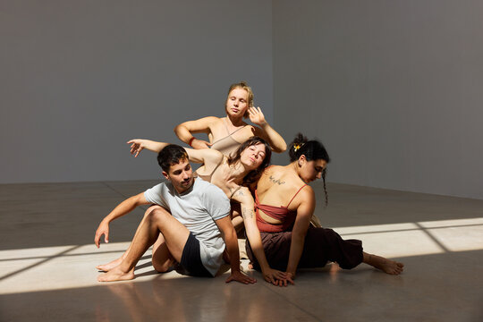 Dancers expressing emotion in a bright studio space