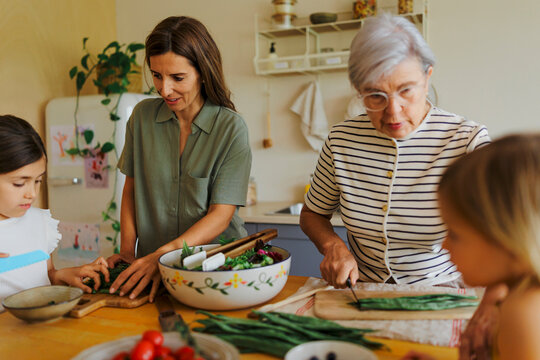 Family preparing healthy meal together in kitchen
