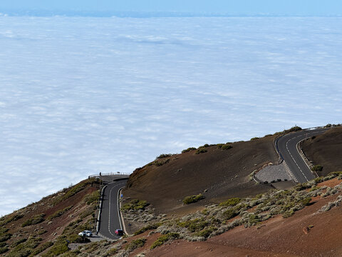 Spectacular view from above the clouds on the El Teide climbing hairpins of the TF-24 road at Tenerife, Spain