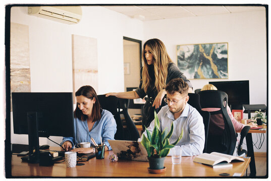 Colleagues discussing project together