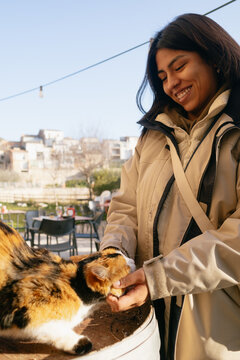 Woman Interacting with a Friendly Cat