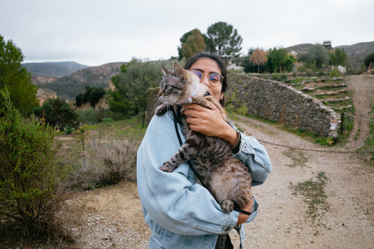 Woman Holding Cat in Countryside