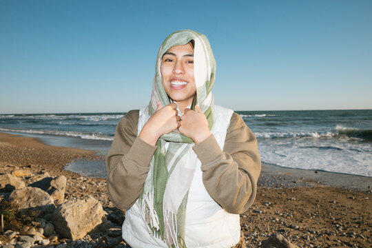 Smiling Individual at the Seashore