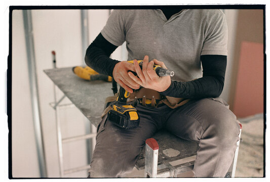Worker holding screw gun