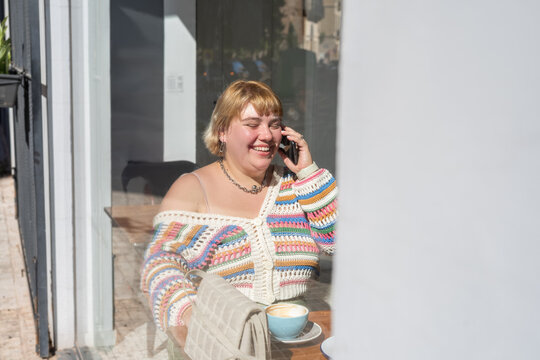 Woman laughing during phone call 