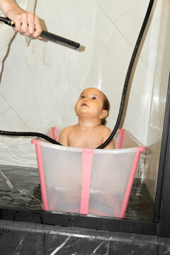 Baby Enjoying Bath Time in a Small Tub.
