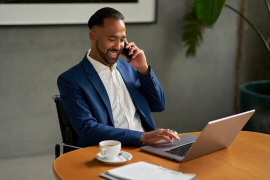 Businessman Working Remotely and Enjoying Coffee in Modern Office